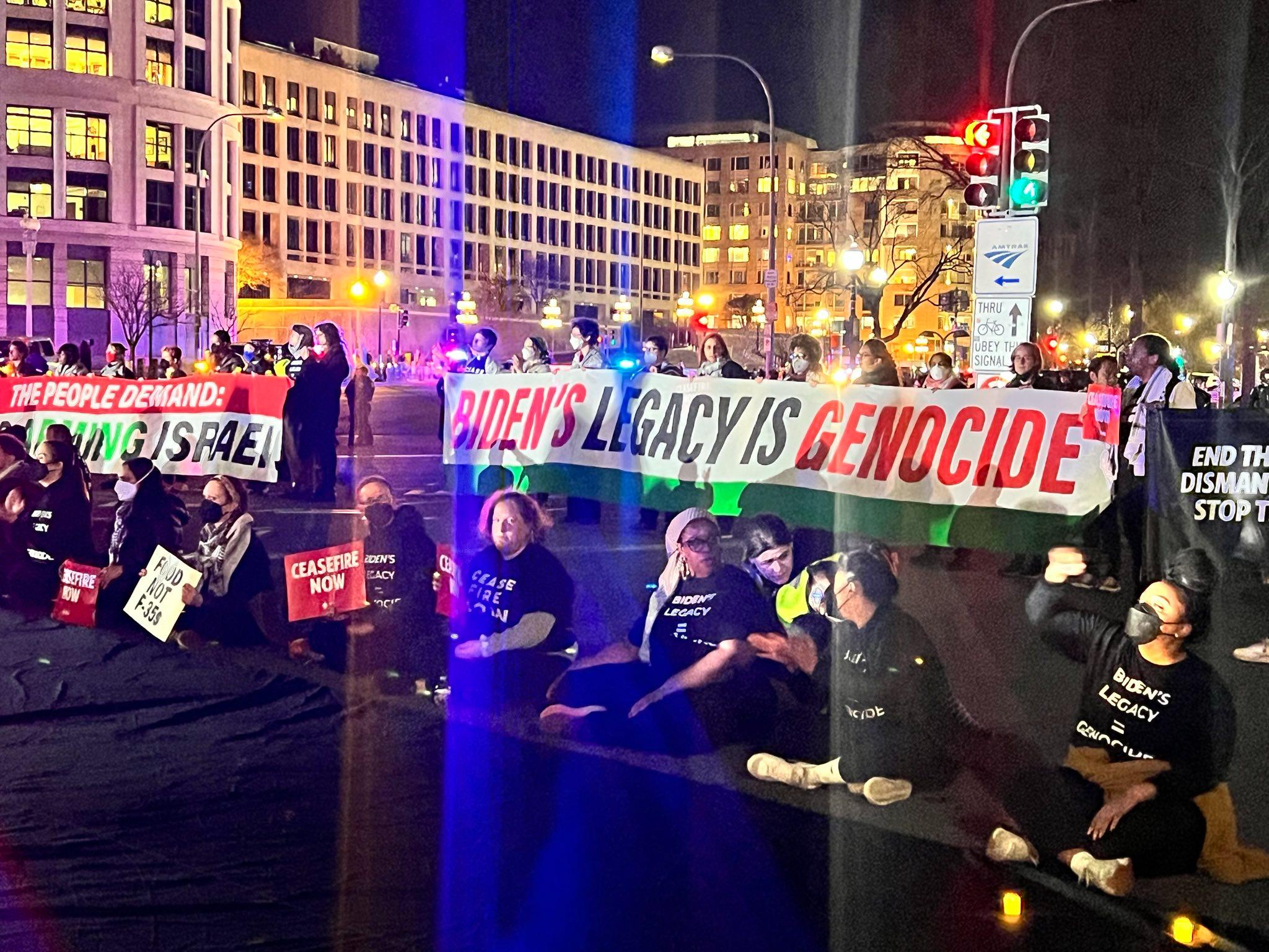 Protestors block the street with sign that reads 