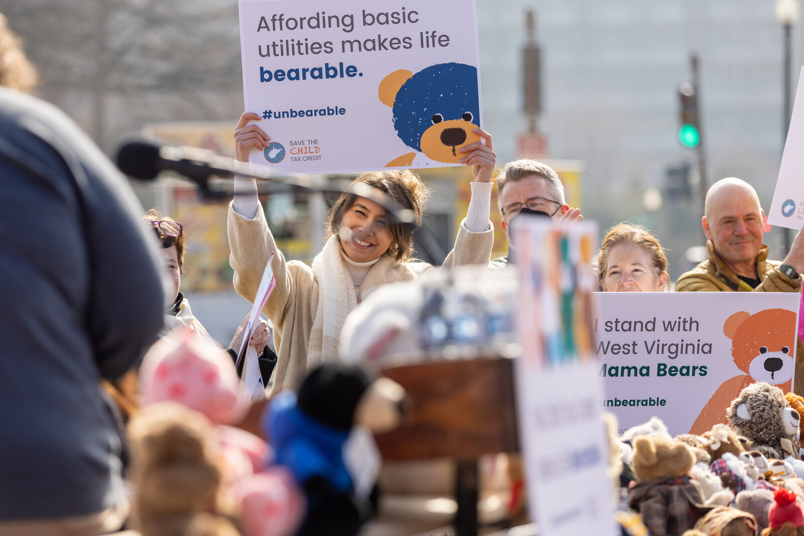 people at an outdoor action holding signs about the child tax credit