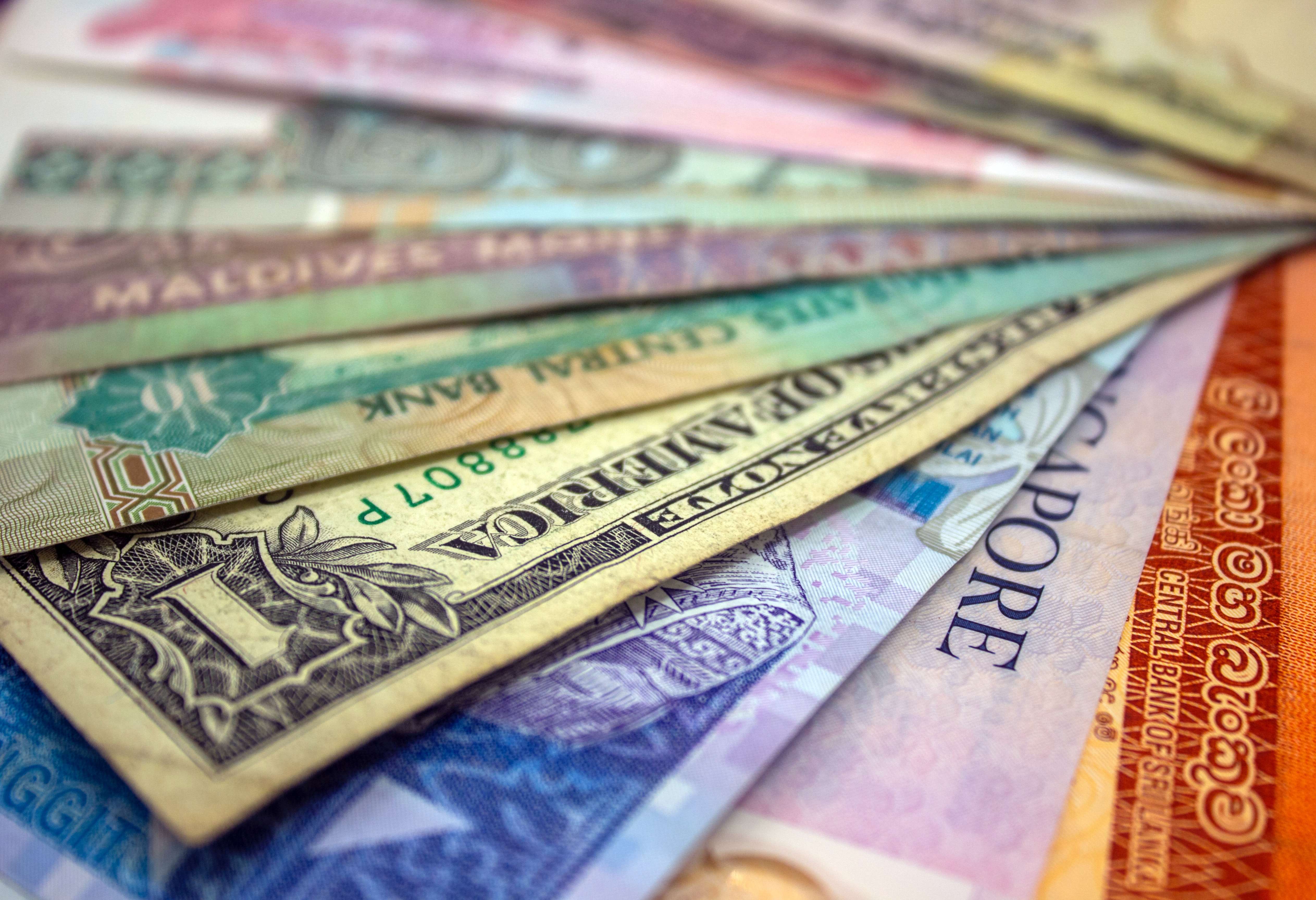 Close up shot of international currencies arrayed on a table