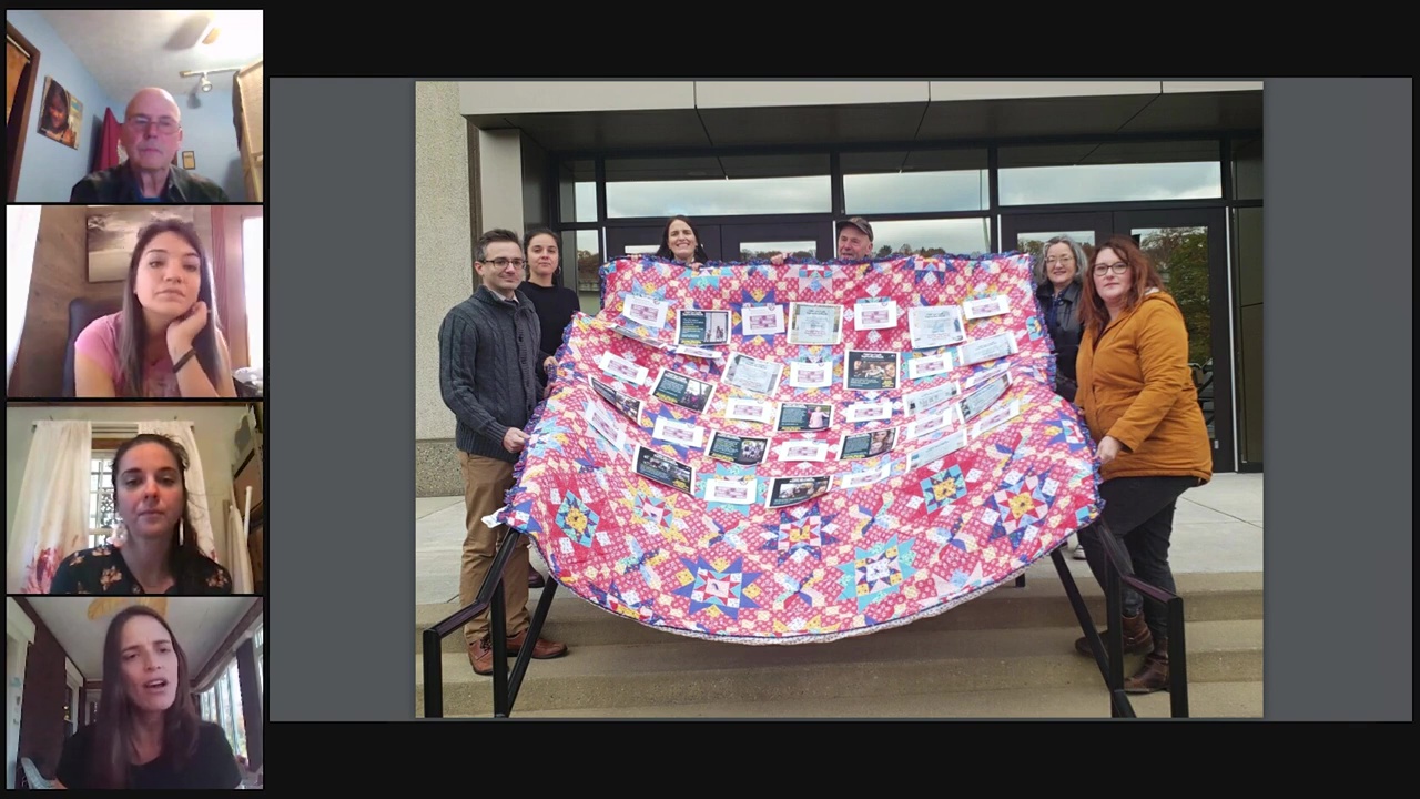 Screenshot of a livestream featuring an imaage of activists holding a quilt