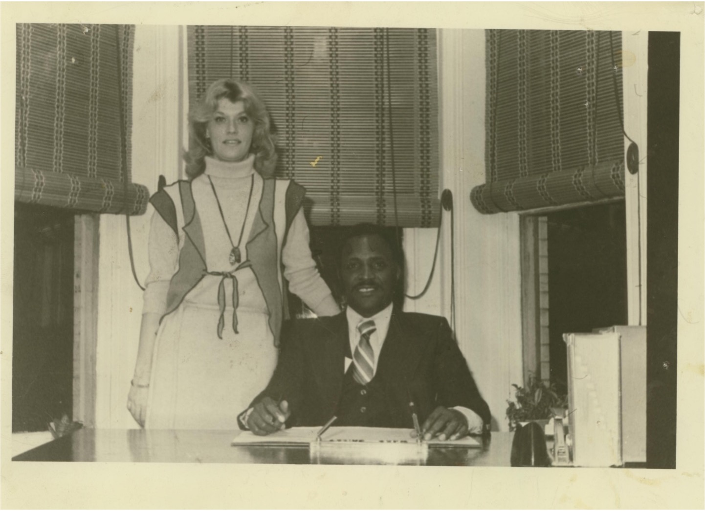archival photo of bonnie standing next to man in AFSC office