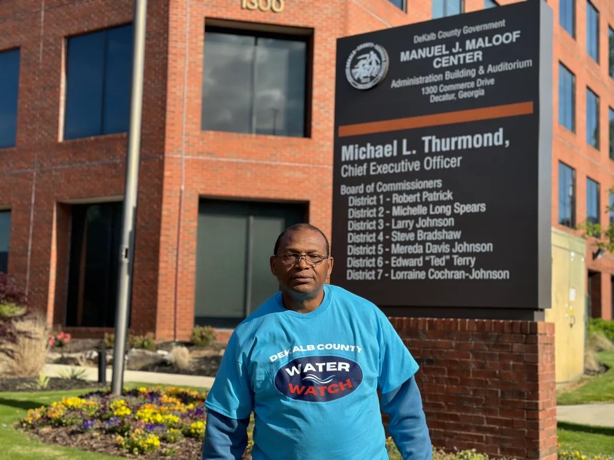 Member of Dekalb water watch stands in front of municipal building