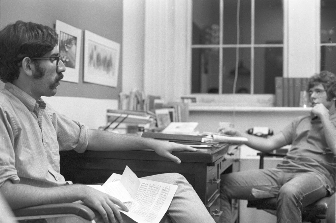 Two men sitting in an office across a desk