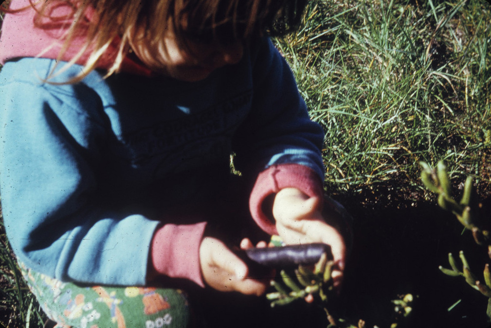 Child holding a sensor linked to a remote bomb