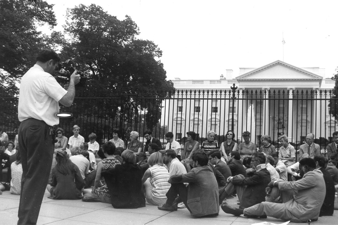 Man filming a group of Quakers in a vigil outside the White House