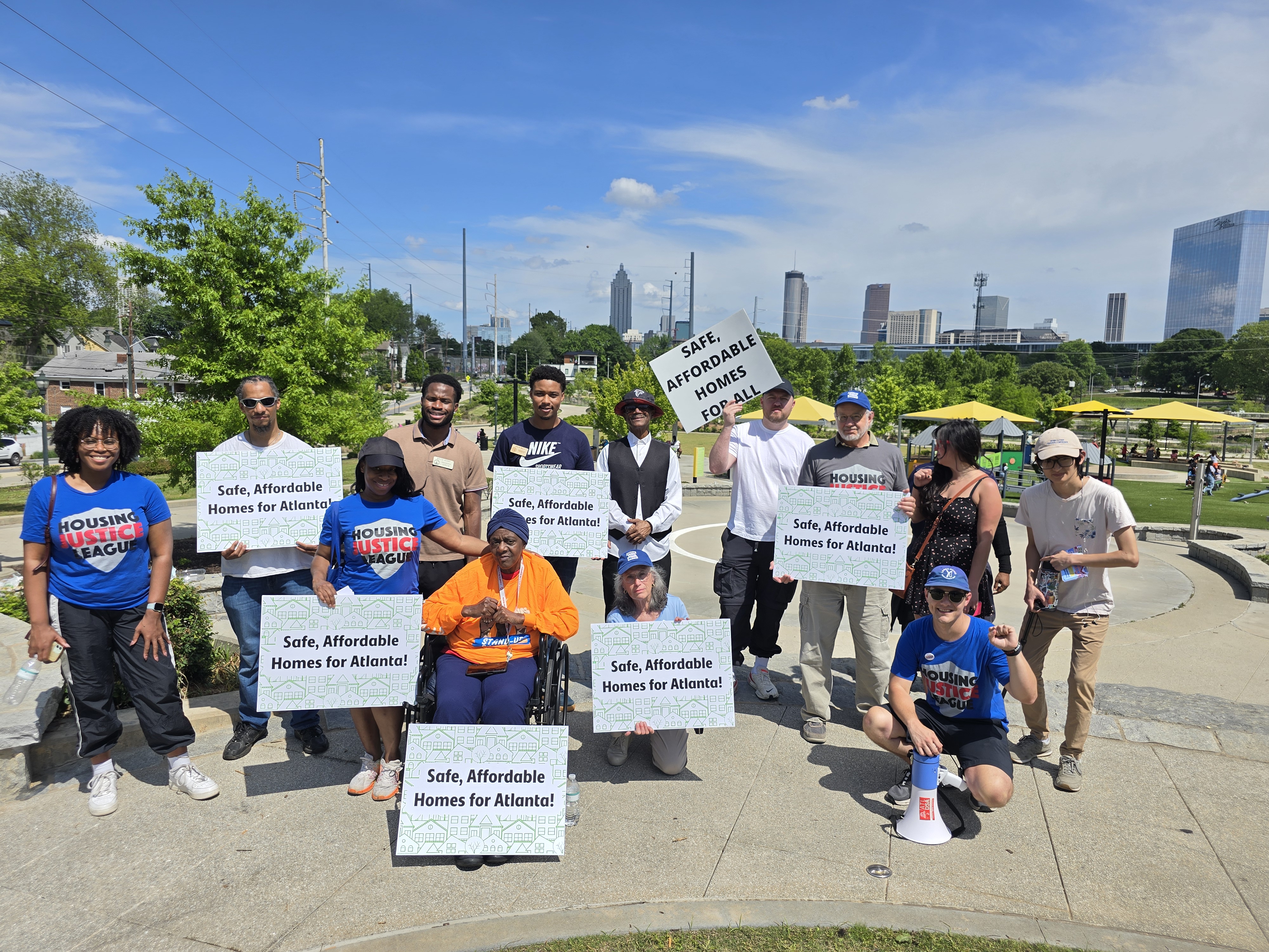 Image of people at a public protest with signs that say