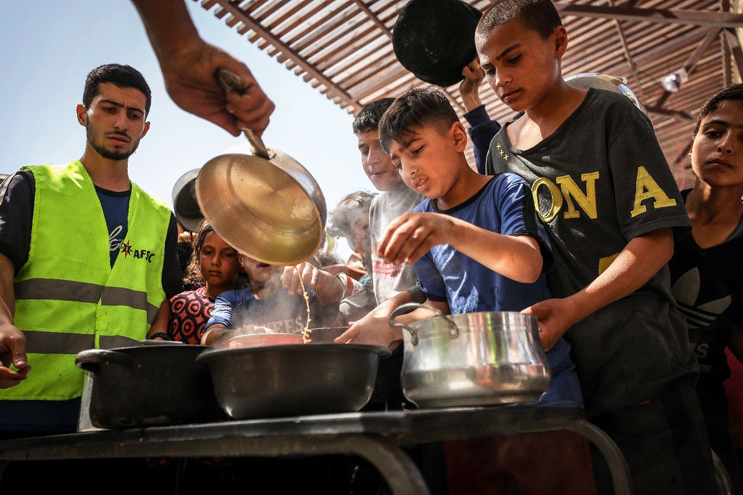 Children at a food kitchen receiving food