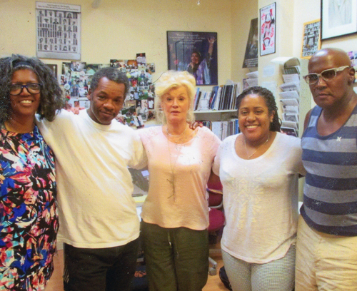 Five people looking into the camera and smiling