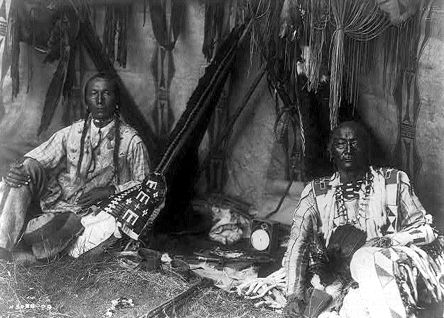 An image by Edward Curtis before editing which includes a clock not present in the edited version, photo in public domain