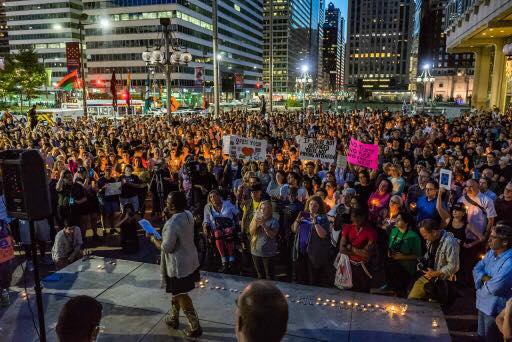 Jude-Laure Denis speaks at Charlottesville rally at Thomas Paine Plaza, photo by Milton Lindsay