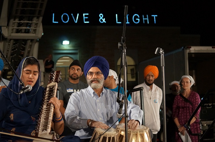 Love and Light light brigade signs at a one year anniversary vigil of the attack of the Oak Creek Sikh temple, photo by Joe Brusky via Flickr CC license