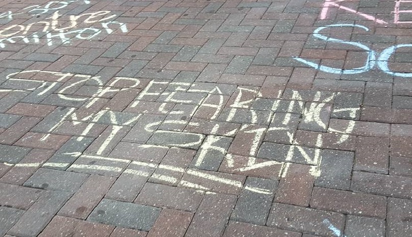 Stop fearing my skin, sidewalk chalk at protest in Charlotte, photo by Lori Khamala