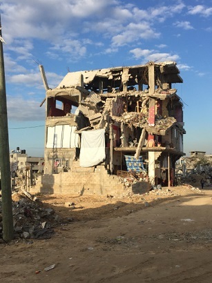 Destroyed building with a family residing on second floor