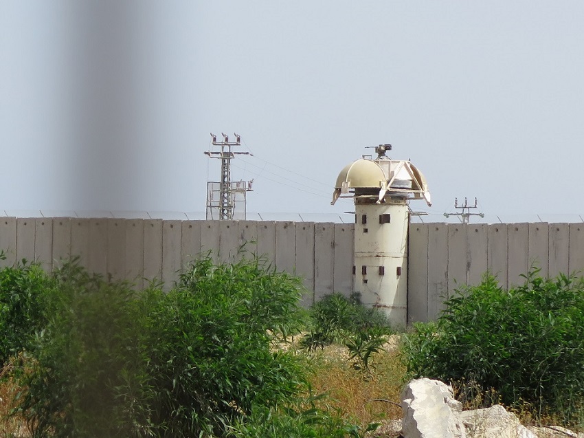 A machine gun on the separation wall at the Erez checkpoint (Photo by Lucy Duncan; AFSC). 