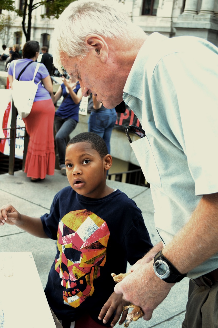 George with his great-grandchild Yasin at Occupy protest in Philadelphia. Photo courtesy of George Lakey.