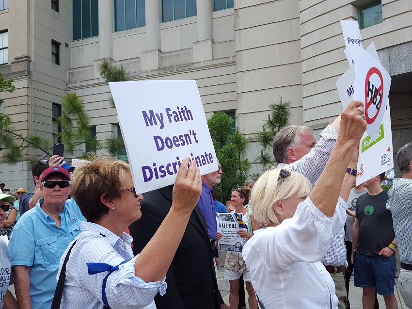 Person with "My faith doesn't discriminate" sign at Moral Monday protest in North Carolina. Photo by Lori Fernald Khamala / AFSC.